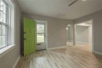 Doorway to outside with light hardwood / wood-styl