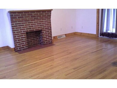 Living Room. The brick fireplace is decorative but