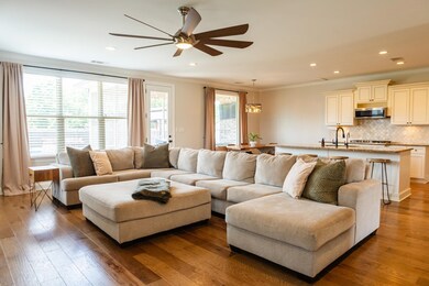 Living area featuring crown molding, ceiling fan, recessed lighting, and wood finished floors