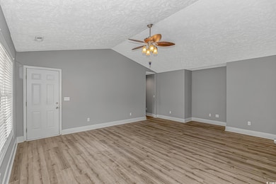 Unfurnished living room featuring ceiling fan, a t