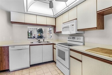 Kitchen featuring light tile flooring, ceiling fan