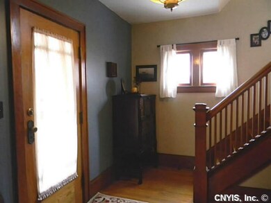 Foyer. Hardwood floors and natural woodwork.