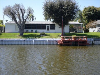 BACK WITH DOCK, SEAWALL AND WIDE CANAL