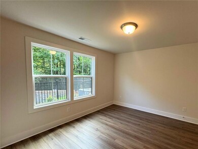 Empty room with baseboards and dark wood-style flooring