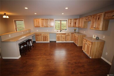 Brand new hickory cabinets, flooring and solid sur