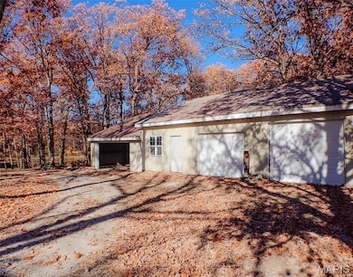 Detached garage with view of scattered trees