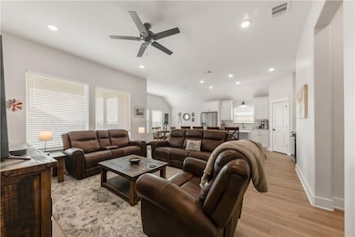 Living room featuring light wood-style floors, cei