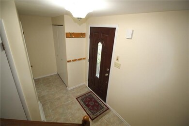 Foyer features newly painted walls and has a coat 