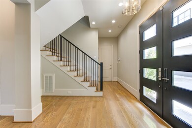 Bright entryway featuring hardwood floors, modern