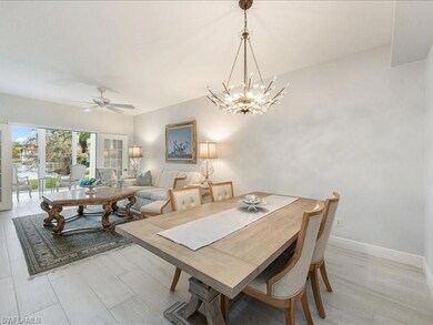 Dining area with ceiling fan with notable chandeli