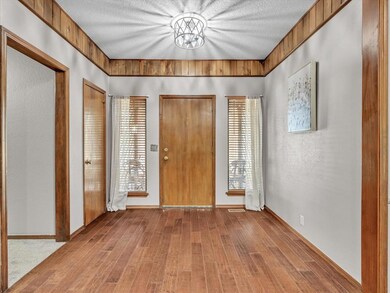 Entryway with wood-type flooring and a textured ce