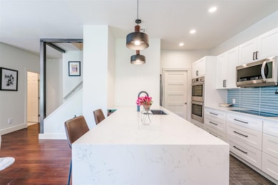 Kitchen featuring white cabinetry, recessed light