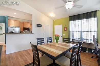 Dining room featuring lofted ceiling, a ceiling fan, light wood-style floors, and baseboards