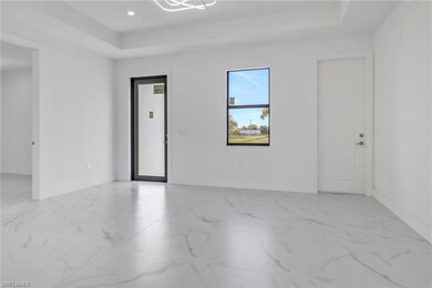 Unfurnished room with a tray ceiling