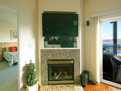 Beautifully tiled gas fireplace w/marble hearth