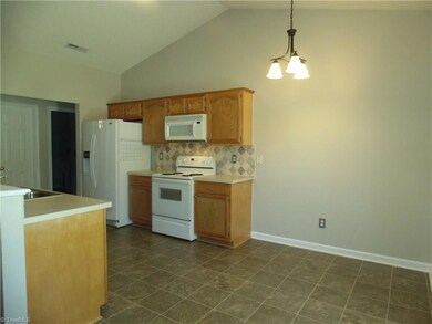 Kitchen with tile backsplash and refrigerator remains