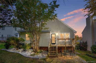 Back house at dusk featuring a deck