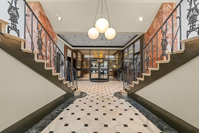 Entryway with stairway, inlaid floor details, rece