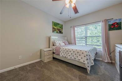 Carpeted bedroom with baseboards and ceiling fan