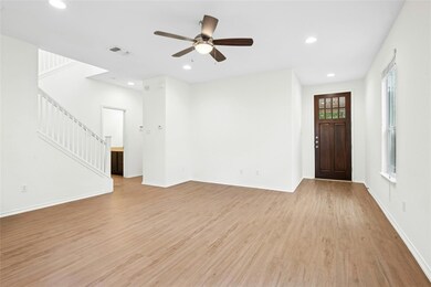 Unfurnished living room with stairs, light wood-t