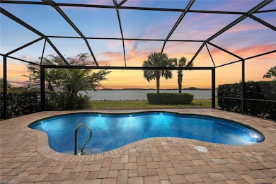 Pool at dusk featuring an outdoor pool, a lanai, and a patio area