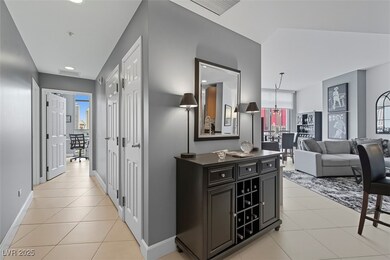 Hall with light tile patterned flooring and recessed lighting
