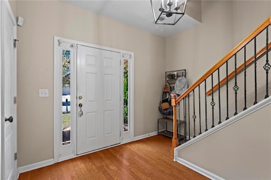 Entryway with an inviting chandelier, baseboards, 