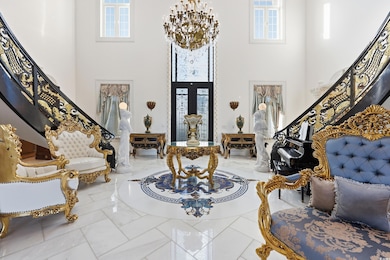 Foyer featuring stairway, a chandelier, and a towering ceiling