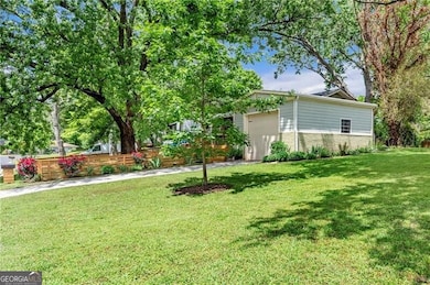 View of yard with fence and a garage