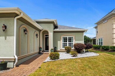 Property entrance featuring a shingled roof, stucc
