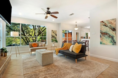 Living area with light tile patterned flooring, c