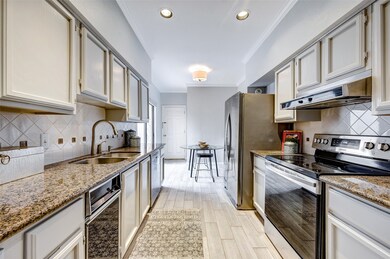 Wood like tile flooring continues into the kitchen