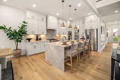 Your gourmet kitchen comes equipped with a gas cooktop, showstopper island and cabinetry for days! Pic is of model home and includes just some of the options you have available to you!