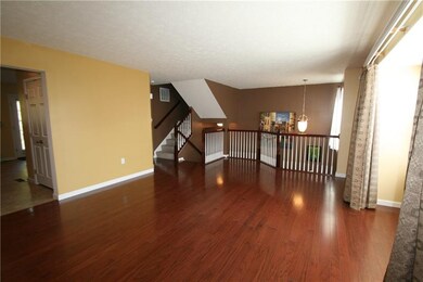 Living room with hardwood floors and open to the s