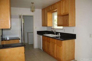 kitchen with newer cabinets and granite counter to