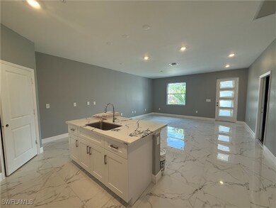 Kitchen featuring light marble finish flooring, re
