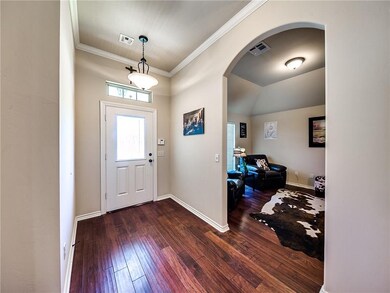 Warm inviting entry with arched doorway entry into