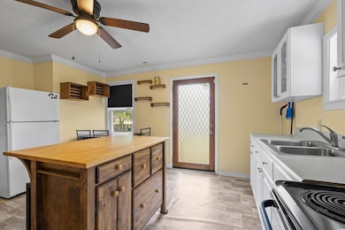 Kitchen with range with electric cooktop, white fr