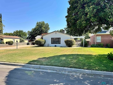 View of side of property with a lawn