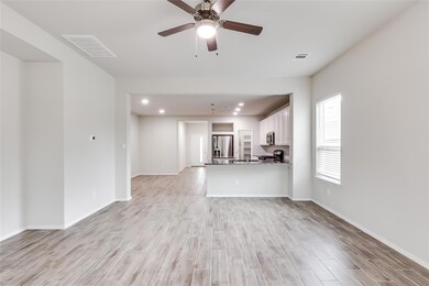 Unfurnished living room featuring baseboards, lig