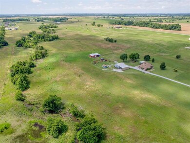 Aerial view of property and surrounding area with rural landscape