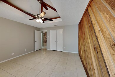 Unfurnished bedroom featuring ceiling fan, a textu