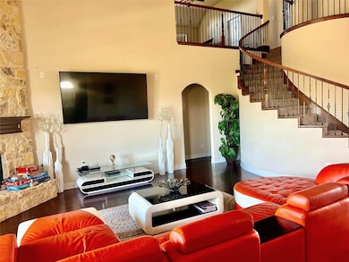 Living room with a fireplace, a towering ceiling