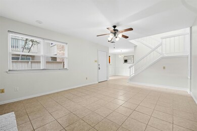 Unfurnished living room with stairs, light tile p