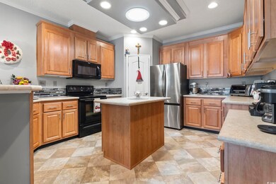 Kitchen with a kitchen island, crown molding, and 