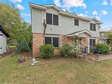 View of front of property with a front yard and brick siding