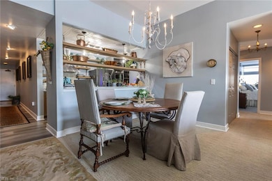 Dining area with chandelier and view of hall