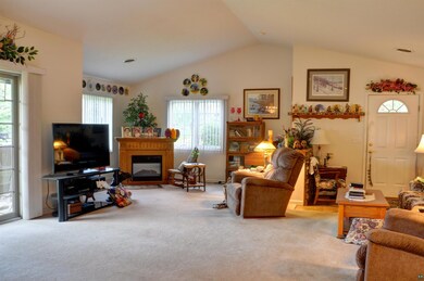 Living room featuring lofted ceiling and carpet fl