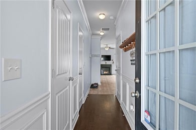 Hallway with a decorative wall, visible vents, orn