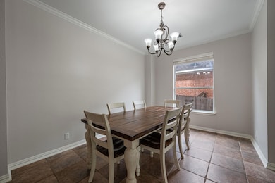 Dining space with a chandelier, ornamental moldin